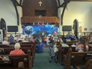 Kids performing a song from VBS for their families.